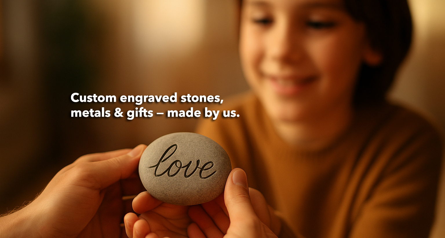 Person holding a stone engraved with 'love' in front of a blurred child, with text about custom engraved stones and gifts.