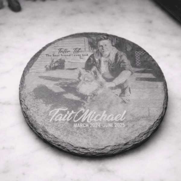 A Custom Laser Engraved Slate Coaster on marble, featuring an image of a man and a dog. Text: Tait Michael, March 2024 - June 2025. The best friend I ever had.