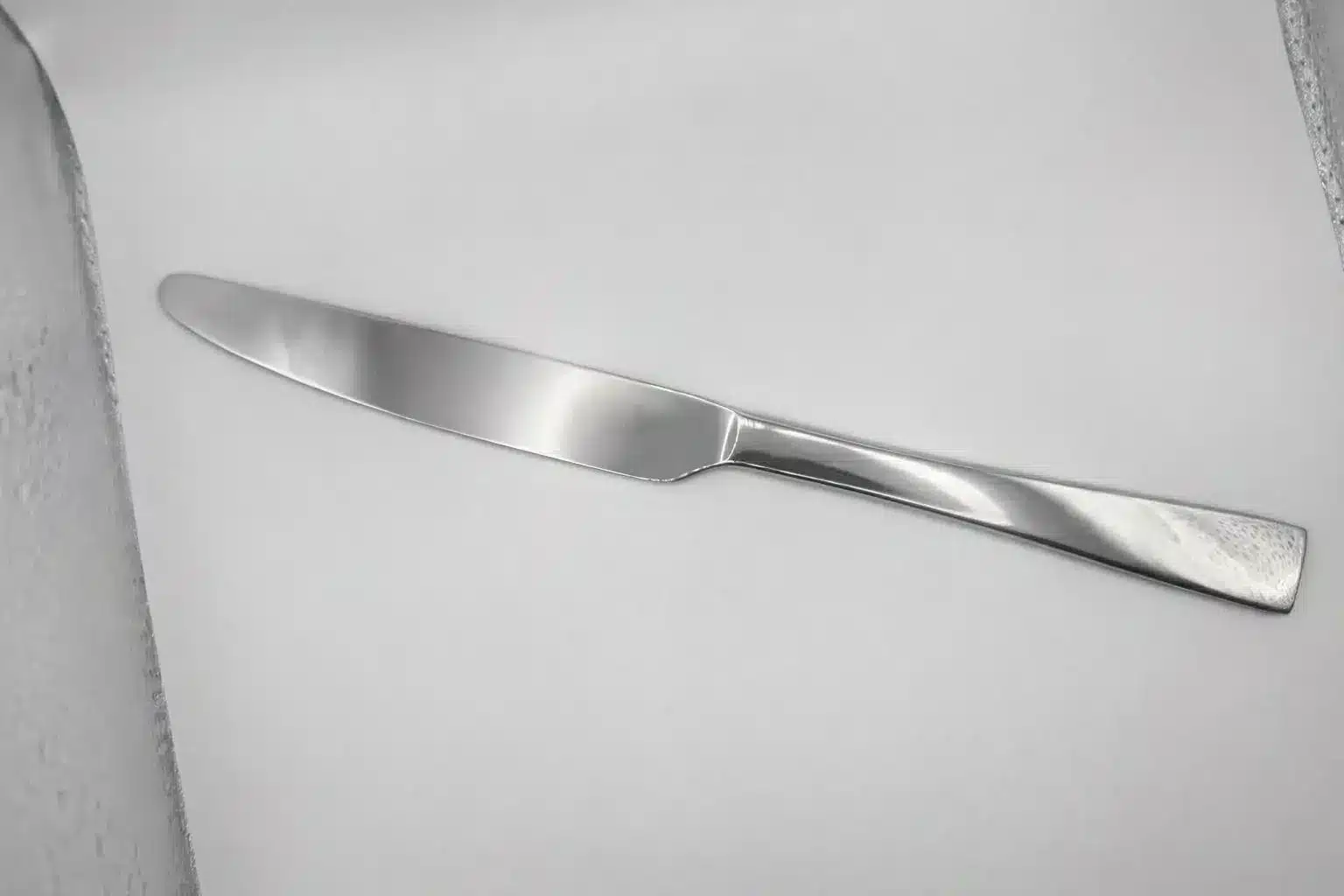 A Premium 9.5 Inch Personalized Butter Knife made of stainless steel is placed on a white surface and photographed from above.