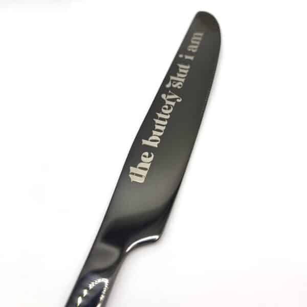 A 9" Custom Engraved Black Knife featuring the text "the buttery slut i am" on its blade, displayed on a plain white background.