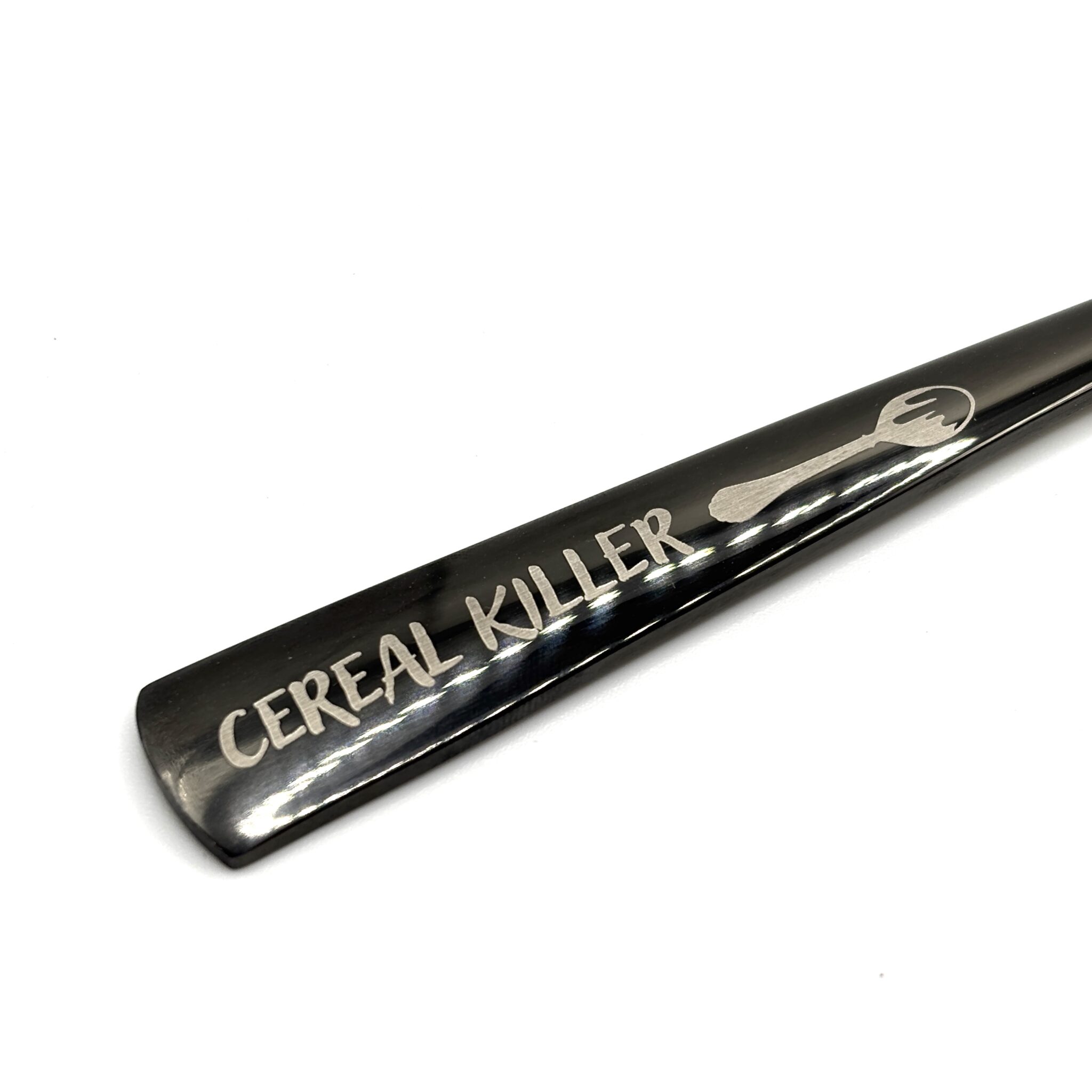 The 8.75" Custom Black Engraved Spoon features a playful handwritten-style inscription, "CEREAL KILLER," beside a small spoon image engraved on the metal handle.