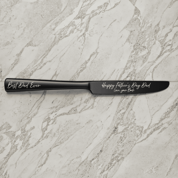A 9" Custom Engraved Black Knife on a marble surface, featuring "Best Dad Ever" on the handle and "Happy Fathers Day Dad, Love your Bride" in white script on the blade.