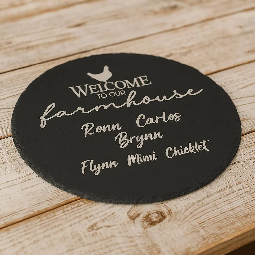 A round slate sign on a wooden surface reads: Welcome to our farmhouse. Ronn, Carlos, Brynn, Flynn, Mimi, Chicklet in white script, with a small chicken graphic above the text.