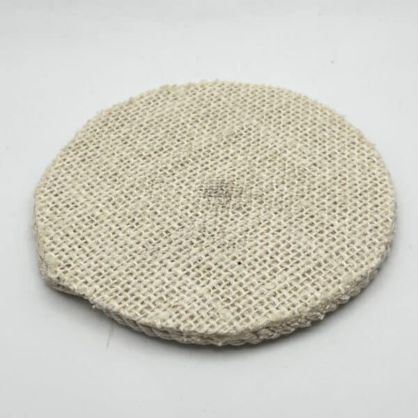 A round, flat, woven beige pad with a slightly uneven edge, placed on a plain white background.