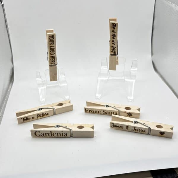Seven wooden clothespins with handwritten labels, including Gardenia, From: Sanjai, James & Jessica, Pedro + Pristine, Thank you for coming! and Your love is appreciated, arranged on a white background.