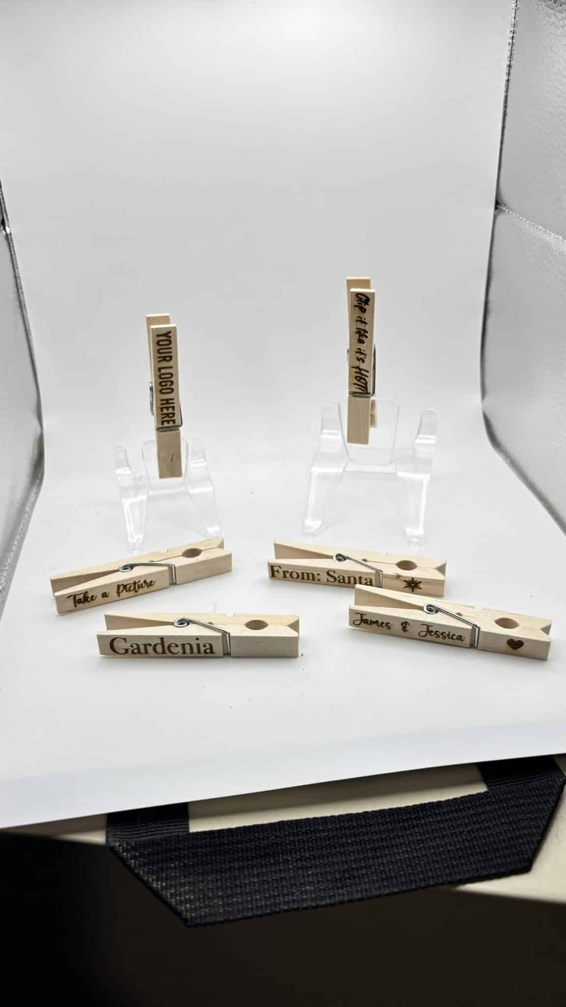 Seven wooden clothespins with handwritten labels, including Gardenia, From: Sanjai, James & Jessica, Pedro + Pristine, Thank you for coming! and Your love is appreciated, arranged on a white background.